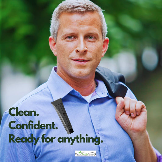 A confident man, aged 30s-50s, with a subtle smile and a jacket over his shoulder. The MensYouthShop Daily Face Wash product is overlaid, with text "Clean. Confident. Ready for anything."